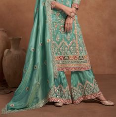 COLOR : Sea Green FABRIC : Top, Bottom, Dupatta - Fancy Silk WORK : Zari Embroidery, Sequins, Resham Work, Foil Mirror Work, Embellished Border OCCASION : Wedding, Party Wear, Festival READY-TO-WEAR : No STITCHING : Available as semi-stitched fabric, can be stitched using standard size option (+$30). Note: There might be a slight color variation due to lighting and flash used during photoshoot. The bright shade seen is the best closer view of fabric's color. Sea Green Fabric, Resham Work, Zari Embroidery, Palazzo Suit, Mirror Work, Sea Green, Salwar Suits, Green Fabric, Silk Fabric