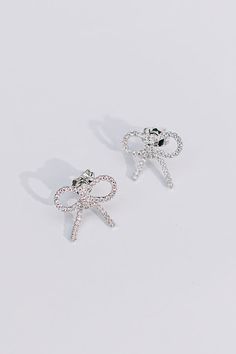 - Tie your look together with a touch of glam with these shimmering earrings! - Sparkling rhinestones - Bow shaped studs - Length: 1 inch Silver Cubic Zirconia Bling Earrings, Diamond White Earrings With Rhinestones, Crystal Diamond Earrings Gift, Dazzling Sterling Silver Sparkling Crystal Earrings, Glamorous Sparkling Earrings As Gift, Glamorous Sparkling Earrings For Gift, White Rhinestone Crystal Earrings, Cubic Zirconia Rhinestone Earrings For Gift, Diamond White Crystal Earrings With Rhinestones