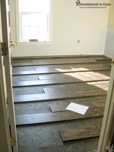 an empty room with hard wood flooring in it