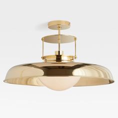 a large brass light fixture on a white background