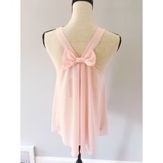 Light Pink Bow Back Tank Top From Alythea, New With Tags. Racerback Style Straps And Single Pleat On Front Of Top Underneath Scoopneck. There Is A Small Mark On One Of The Shoulders, But It Should Probably Come Out In Wash - Just Haven’t Done So Because It’s New With Tags :). Bought From Local Boutique Similar To Anthropologie. Size Medium. Pink Feminine Top With Tie Back, Feminine Pink Tie-back Top, Feminine Pink Tie Back Top, Chic Pink Top With Tie Back, Chic Pink Backless Top, Chic Pink Tie Back Top, Pink Summer Top With Tie Back, Pink Summer Tops With Tie Back, Feminine Sleeveless Top With Bow Tie Back