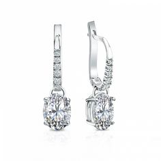 Dangle studs 4-prong basket set diamond earrings make an elegant statement for any occasion. These 18k white gold earrings can last a lifetime. The earrings feature oval-cut natural diamonds with 1.50 ct. total weight for center stone and with 0.10 ct. total weight of small dazzling round-cut diamonds as side stone totaling to 1.60 ct. in a complete pair, available in lever back clasps. Black Diamond Pendant, Black Diamond Studs, Halo Diamond Earrings, Solitaire Diamond Pendant, Colored Diamond Rings, Platinum Earrings, Black Diamond Ring, Earrings Dainty, White Gold Earrings