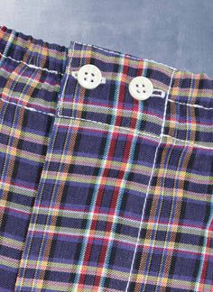 The styling of our woven Perfect Boxer in Multi Purple Plaid has been meticulously honed to provide the perfect rise and fit. The fit does away with all excess, baggy fabric and is as comfortable when worn under a pair of slim 5-pocket jeans as under dress pants. Our boxer features bespoke details found only in exclusive custom-made boxers. There are two operable buttons at the waist, as well as a functional fly opening. The waistband elastic is fully covered with pleated fabric running the leng Classic Plaid Cotton Bottoms, Classic Plaid Bottoms With Pockets, Plaid Boxers, Shirting Fabric, Purple Plaid, Pleated Fabric, Under Dress, Boxer Shorts, Green Plaid