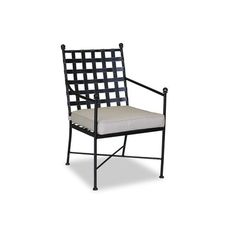 a black and white chair with a cushion on top of it's back legs