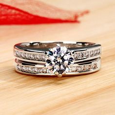 a couple of rings sitting on top of a wooden table