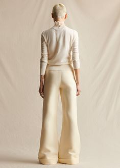 Our classic wide leg trousers made from Italian silk wool. Features an elongating pintuck at the front and a cuff at the ankle. Styled with the Embroidered Top In Pearl Lattice Style Number: AL513SW Made in New York City Size & FitModel's Height: 5'10"Model is wearing size 2 Measurements based on a size 4: Front rise (excluding waistband) 9.625" Back rise (excluding waistband) 14.5" Inseam 36.25" Composition & CareComposition: 77% Wool, 23% Silk Washing Instructions: Dry Clean Only Elegant Cream Pants For Formal Occasions, Elegant Cream Formal Pants, Elegant Tailored Cream Bottoms, Elegant Tailored Cream Pants, Chic Tailored Silk Wide Leg Pants, Tailored Silk Wide Leg Chic Pants, Tailored Cream Wide Leg Pants For Formal Occasions, Elegant Fitted Bottoms With Flared Cuffs, Formal Cream Wide-leg Bottoms