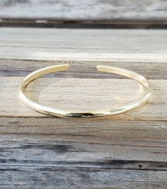 "Create your own set by choosing your size and number of bangles at checkout. Each bangle is just over 1/8\" wide and is made from jeweler's brass. These are slightly wider than our hammered brass bangles. They are very similar in color to 14k gold. Each bangle has been shaped and polished to sparkle. They are not connected, so they \"clink\" on your wrist. They are easily adjustable. Just pull open or squeeze closed for the perfect fit. Jewelers brass is an alloy made of 85% copper and 15% zinc Adjustable Stackable Gold Bracelet For Wedding, Formal Adjustable Stackable Bangle, Classic Adjustable Cuff Bracelet For Wedding, Gold Bangle Bracelet For Bridesmaids, Gold Cuff Bracelet For Bridesmaid Gift, Bangle Jewelry For Bridesmaid Gift, Adjustable Bangle Bracelets For Bridesmaid Gift, Adjustable Gold Bangle For Bridesmaids, Gold Holiday