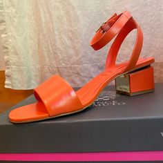 New In Box! Vince Camuto Block Heel Sandal. Orange Leather With Gold Details. Buckle Closure. Cushioned Foot Bed. 2" High Heel. Orange Block Heel Sandals For Evening, Orange Ankle Strap Heels With Stacked Heel, Orange Open Toe Evening Sandals, Chic Orange Open Toe Sandals, Orange Evening Sandals For Summer, Evening Orange Sandals With Heel Strap, Formal Orange Ankle Strap Sandals, Orange Leather Sandals With Low Heel, Orange Sandals With Stacked Heel And Round Toe