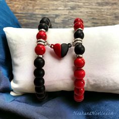 "🤍 Magnetic Heart Bracelet Sets 🤍 Now available in: ❤️🖤 Red Turquoise & Matte Black Onyx 💙🤍 Blue Spot Jasper & White Howlite 💜💜 Purple Sea Sediment Colorful Imperial Jasper 🖤🖤 Black Snowflake Obsidian ⭐️ Sold as a set of 2. Price is for the pair.  📏 Bracelet pictured is size 7\" with a stretch band (medium size), but can be made to order by request." Valentine's Day Black Heart Charm Bracelet, Black Heart-shaped Couples Bracelets, Couples Black Heart Bracelets, Couples Black Heart-shaped Bracelets, Black Beaded Bracelets With Heart Charm As Gift, Handmade Black Bracelets For Valentine's Day, Handmade Black Bracelet For Valentine's Day, Black Heart Beads Bracelets For Valentine's Day, Black Bracelets With Heart Beads For Valentine's Day