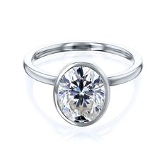 a white gold ring with a round cut diamond in the center, on a white background