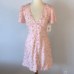 Billabong Pink Floral Button Down Dress . Brand New With Tags. Size Medium. Pink Floral Pattern Button Down Dress By Billabong. Short Sleeves. V Neckline. Tie Closure Along Backside Of Dress. Cute Button-up Spring Dresses, Pink V-neck Dress With Button Closure, Fitted Summer Mini Dress With Buttons, Fitted Buttoned Mini Dress For Summer, Pink V-neck Dress With Buttons, Spring Mini Dress With Button Back, Spring Short Sleeve Dress With Button Back, Cute Summer Button-up Dresses, Cute Button-up Summer Dresses