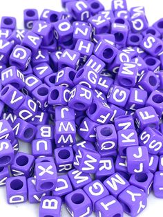 purple alphabet beads with white letters on them