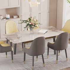 a dining room table with yellow chairs and a white marble topped table in the middle