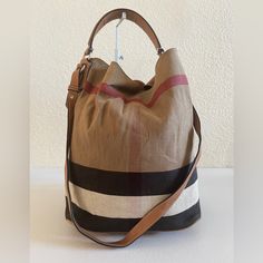 Burberry Ashby Shoulder Bag. Interior Comes With A Detachable Canvas Slip Pockets And A Zip Pocket With The Brand Logo. Exterior Is Made From Canvas, Features Leather Handle, Strap And Trims, Hook-Like Closure, Metal Fittings, Protective Feet Base. Condition: Interior Is Neatly Used, Creasing On Canvas, Mild Storage Odor, Scuff Marks, No Rip No Tear. Exterior Shows Used, Creasing On Canvas, Minimal Signs Of Aging On Leather, Scuff Marks, Roughness On Corner Edges, Hardwares Shows Scratches. H:13 Designer Hobo Bag With Detachable Strap For Errands, Bag Interior, Burberry Bag, Hobo Bag, Leather Handle, Brand Logo, Zip Pockets, Burberry, Bag Lady