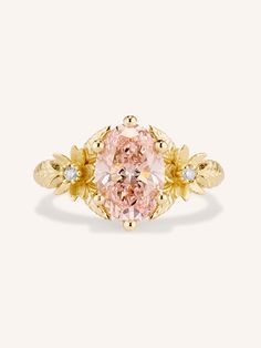 a pink diamond ring with leaves on it