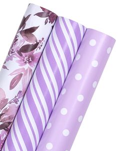 three rolls of purple and white wrapping paper