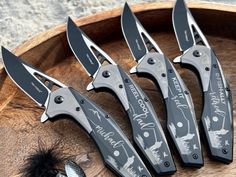 four knives are sitting on top of a cutting board