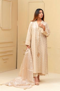 Expertly crafted from luxurious khaadi silk, this beige shalwar kameez boasts a stunning jamawar mesore dupatta and silk trousers. The hand sewn pearl details on the sleeves and neckline add a touch of elegance to this traditional ensemble. Elevate your style with this timeless piece. 3-Piece Suit Festive Slub Silk Kurta With Naqshi Detail, Formal Chanderi Dupatta With Naqshi Detailing, Formal Naqshi Chanderi Dupatta, Formal Chanderi Unstitched Suit With Naqshi, Silk Salwar Kameez With Naqshi Embroidery, Straight Kurta, Silk Salwar Kameez With Naqshi In Straight Kurta Style, Silk Salwar Kameez With Naqshi Straight Kurta, Silk Salwar Kameez With Naqshi Embroidery, Festive Slub Silk Kurta With Naqshi