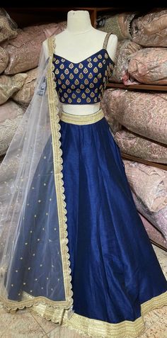 Navy blue plain lehenga with gold border teamed with beautiful cut dana and stone work blouse and contrasting ivory net dupatta. Fabric: Silk Occasion: Wedding Ceremony or Reception. WASH CARE INSTRUCTIONS - Please Dry clean only when it is applicable. Slight color variation is possible due to digital photography. This outfit can be customized in multiple colors and specific to client measurements. 120 days of production time is required and are for bulk orders only!Order are processed in store Affordable Blue Dupatta For Navratri, Lehenga Designs Blue Colour, Navy Blue Chaniya Choli, Churidar For Onam, Nevi Blue Lehenga, Blue Lehenga Contrast Blouse, Dark Blue Lehenga Combination, Navy Blue Contrast Color Dress, Royal Blue Lehenga Simple