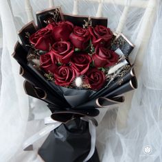 a bouquet of red roses sitting on top of a white chair