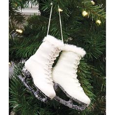 an ornament hanging from a christmas tree decorated with snow boots and laces