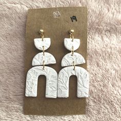 the earrings are made out of white marble and gold - plated brass hardwares