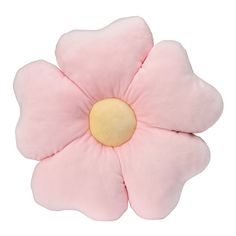 a pink flower shaped pillow sitting on top of a white surface with a yellow center