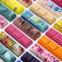 many different colored bars of soap sitting on top of each other