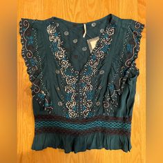 New, With Tags And Extra Replacement Beads Free People Beautiful Embroidered And Beaded Top. Stunning Dark Teal Blue Color. Incredible Details On Front And Back. Size: Small Retails $128 No Free People Tags Attached, Just The Store Tags Where It Was Purchased. Please See Photos And Ask Any Questions. I’m Pregnant So I’m Doing A Closet Clean Out. Bundle 2+ Items To Save 10% Plus Shipping Fees. Smoke Free, Pet Free Home. Fitted Turquoise Bohemian Tops, Fitted Bohemian Turquoise Tops, Blue V-neck Embroidered Top For Beach, Blue Embellished V-neck Top, Embellished Blue V-neck Top, Blue Bohemian Top With Embroidered Neckline, Blue Bohemian Tops With Embroidered Neckline, Bohemian Blue Tops With Embroidered Neckline, Beaded V-neck Top For Festivals