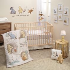 a baby's room with winnie the pooh crib and teddy bear pillows