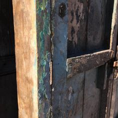 an old wooden door with peeling paint on it