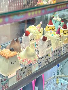 a display case filled with lots of different types of cakes on top of each other