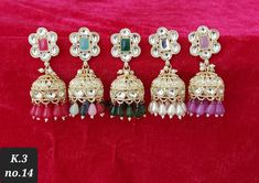 Presenting an exquisite pair of gold-finished dangler earrings adorned with white Kundan polki and colored stones, set delicately in copper. Ideal for festive occasions or wedding ceremonies, these earrings epitomize refined elegance. The additional touch of sophistication is imparted by the matching colored pearls gracefully suspended from the bottom tier, adding an extra layer of grace and allure to the overall design.  Jewelry care instructions : Keep jewelry away from direct heat,water,perfu Elegant Zari Work Danglers For Festivals, Elegant Zari Work Danglers For Celebration, Elegant Danglers With Zari Work For Celebration, Elegant Festival Zari Work Danglers, White Earrings For Festive Eid Occasions, White Festive Earrings For Eid, Elegant Jhumkas With Zari Work For Celebrations, White Festive Drop Jhumkas, Multicolor Zari Work Earrings For Celebration