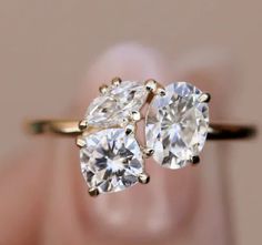 two pear shaped diamond rings on top of each other