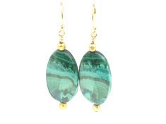 "Your friends will be green with envy when you wear this stunning matched pair of malachite earrings.  The earring is 1 1/4\" long with its' drop length 1 3/4\".  Each malachite oval is bracketed on top and bottom with a cubed gold bead.  They are suspended from 14k gold filled ear wires and are one of a kind. Please contact me BEFORE PURCHASE for the correct shipping costs outside of the Continental USA.  Thank you. Click on the link below to visit my shop: https://www.etsy.com/shop/cherylpeter Elegant Green Chrysocolla Jewelry, Elegant Green Agate Earrings, Agate Gemstone Drop Earrings, Green Agate Drop Earrings, Green Chrysocolla Gemstone Jewelry, Green Spiritual Earrings For Gift, Spiritual Green Earrings For Gift, Green Onyx Drop Earrings, Green Agate Dangle Earrings