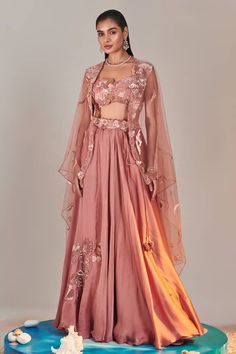 Pink sheer cape with sequin embroidered floral patterns. Comes with padded embroidered applique blouse, can can attached lehenga skirt and cut-out belt. - Aza Fashions Organza Cape, Sequins Lehenga, Peach Lehenga, Cape Lehenga, Sheer Cape, Applique Blouse, Kurta Lehenga, Sequin Cape, Lehenga Pattern