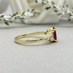 This beautiful ring is made from genuine 925 sterling silver with yellow gold plating. Ring details- -The Main stone is an oval cut 8mm by 6mm Lab Ruby -Side stones are 4mm by 2mm clear Marquise and 1.3mm Round simulated diamonds -Ring is casted in solid 925 sterling silver with yellow gold plating (rose gold and rhodium plated also available, please check the drop down menu for more options) -The Total face height of the ring measures 8mms and the band width measures 1.3mms -Each ring is handma Gold Proposal Rings With Accent Stones, Gold Rings With Accent Stones For Proposal, Gold Marquise Wedding Ring With Accent Stones, Gold Ruby Ring With Marquise Accent Stones, Oval Yellow Gold Cluster Ring For Proposal, Gold Marquise Ruby Ring For Gift, Gold Oval Cluster Ring For Proposal, Oval Gold Ruby Ring For Wedding, Gold Oval Rings For Wedding Proposal