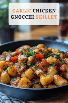 garlic chicken gnocchi skillet in a black bowl on top of a wooden table