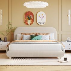 a white bed sitting in a bedroom on top of a hard wood floor