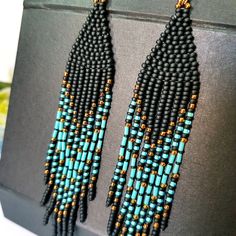 Blue Turquoise ,Matt Black and bronze color combination.Long tassel earrings. Beaded earrings. native American style .Fringe earrings .Seed Bead Earrings .Boho earrings . Materials;Sterling silver ear wire. High quality japanese beads 3 shades. This bead does not lose its color and does not darken. Earrings length 4.5 inches (11cm) You can see a large selection of earrings on my page https://www.etsy.com/il-en/shop/JewelryByElenaZar?ref=seller-platform-mcnav§ion_id=25458740 Bohemian Tassel Earrings With Black Beads For Gift, Bohemian Black Tassel Earrings With Round Beads, Black Bohemian Tassel Earrings With Round Beads, Bohemian Black Beaded Tassel Earrings Gift, Bohemian Black Tassel Earrings As Gift, Black Tassel Drop Earrings With Colorful Beads, Black Tassel Earrings With Colorful Beads For Gift, Black Bohemian Long Drop Earrings, Bohemian Black Tassel Earrings With Dangling Beads