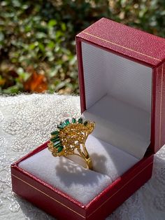 We have a beautiful gold tone vintage emerald green gemstone cocktail style ring. This ring is one of our personal favorites from our collection. We just don't have any room for it anymore! This ring would be perfect for a statement ring or even as a gift!  The ring is secondhand and does have minor markings but still very wearable! Please see attached photos for better description of the ring!  The ring is a size US size 7 1/2 Formal Gold Emerald Crystal Ring, Gold Emerald Cluster Ring For Formal Events, Gold Emerald Cluster Ring For Formal Occasions, Gold Crystal Ring For Formal Occasions In May, Gold Crystal Ring For May Birthstone Formal Occasion, Gold Crystal Ring For May Birthstone Events, Gold Cluster Ring For May Birthstone, Vintage Emerald Cluster Ring As Gift, Vintage Emerald Cluster Ring As A Gift