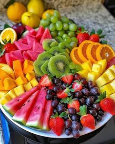 a platter filled with lots of different types of fruit