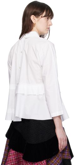 Cotton poplin blouse. · Peter Pan collar · Raw edges at tiered peplum hem · Asymmetric hem · Button closure at back Supplier color: White