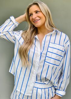 Get ready for summer with our Tiffany Striped Button Down Shirt! This blue and white striped shirt is the ultimate summer classic, perfect for beach or lake days. Lightweight and versatile, it's great to wear on its own or layer with our Tiffany Striped Poplin Shorts. Just throw it on and go for a stylish and effortless look! True to size Olivia is wearing a size small Button down top Functioning buttons Loose fit Front pocket Fabric content: 100% Cotton Fabric has no stretch Striped Button-up Shirt For Day Out, White Vertical Stripes Top For Beach, Spring Horizontal Stripe Button-up Shirt, Spring Button-up Shirt With Horizontal Stripes, White Vertical Stripes Top For Vacation, Striped Button-up Beach Shirt, White Summer Shirt With Striped Collar, Striped Button-up Vacation Shirt, White Horizontal Stripe Button-up Top