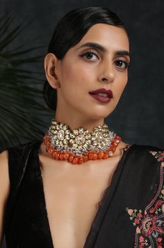 Intricate 22k Gold plated kundan choker necklace based on copper alloy. Necklace Size - 14 inches. Closure - Adjustable dori. DETAILS -100% top Quality -Faux glass polki -22K gold plated silver copper alloy. -Handcrafted in our all girls workshop in Paisley Pop Studio, Jammu and Kashmir Style Tip - This traditional necklace set with a modern update is set to take you through weddings and festivities in style. Perfect accessory for the woman who likes to stand out from the crowd. Pair it with any Orange Jewelry For Diwali Puja, Orange Temple Jewelry For Gifts, Orange Temple Jewelry As A Gift, Handmade Orange Jewelry For Puja, Orange Temple Jewelry Gift, Traditional Orange Necklaces For Festivals, Festive Orange Jewelry For Gift, Festive Orange Jewelry Gift, Fusion Style Kundan Choker With Tilla