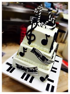 a three tiered cake with musical notes on it