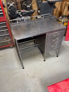 a metal desk with drawers in a garage