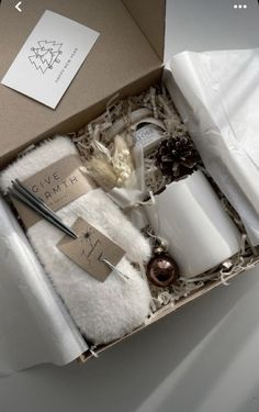 an open box containing candles and other items