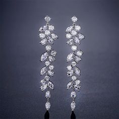 two pairs of diamond earrings are shown on a black background with the words zakol written