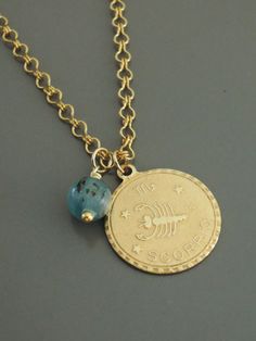 "This is such a fabulous Scorpio necklace! A vintage golden brass pendant with a gorgeous Aquamarine birthstone bead. The vintage brass chain is exquisite. I do have all 12 signs. Chloe says, \"Wear it and feel fabulous!\" The pendant is 1\" round. If you would like the necklace a different length let me know. Thanks for visiting Chloe's" Personalized Brass Amulet Jewelry, Gold Dangle Charm Necklace With Birthstone, Vintage Charm Brass Necklace For Gift, Gold Brass Necklaces With Birthstone, Round Brass Charm Necklaces For Jewelry Making, Antique Gold Necklaces With Charms For Gift, Gold Birthstone Necklaces For Healing, Brass Jewelry With Birthstone For Gift, Nickel-free Gold Birthstone Necklace For Anniversary